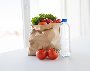 Image showing basket of fresh vegetables and water at kitchen