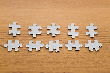 Image showing close up of puzzle pieces on wooden surface