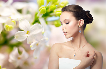 Image showing beautiful asian woman with earring and pendant