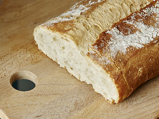 Image showing piece of white cereal bread on wood board