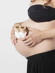 Image showing Pregnant Woman holding her hands on beautiful belly