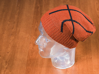 Image showing orange woolen handmade cap basketball ball alike