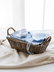 Image showing close up of baby clothes for newborn boy in basket