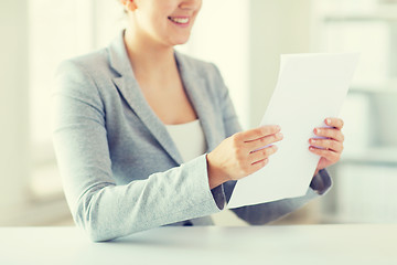 Image showing close up of woman reading papers or tax report