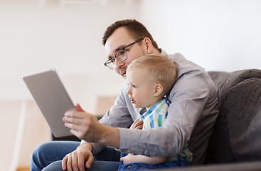 Image showing father and son with tablet pc playing at home