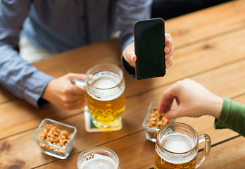 Image showing close up of friends with smartphone and beer