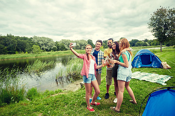 Image showing happy friends taking selfie by smartphone at camp