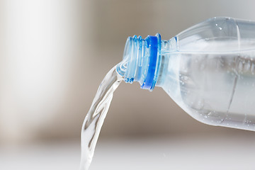 Image showing close up of water pouring from plastic bottle