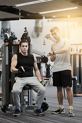 Image showing men exercising on gym machine