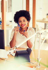 Image showing businesswoman calling on smartphone at office