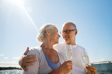 Image showing senior couple drinking champagne on sail boat