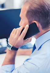 Image showing businessman with smartphone in office