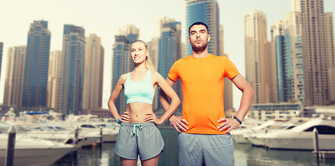 Image showing couple exercising over dubai city background