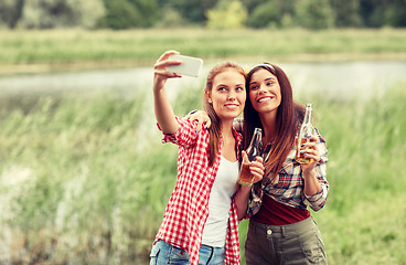 Image showing happy women taking selfie by smartphone outdoors