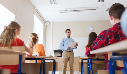 Image showing group of students and teacher with papers or tests