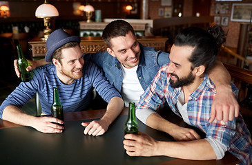 Image showing happy male friends drinking beer at bar or pub