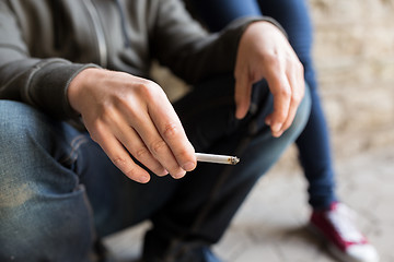 Image showing close up of young man smoking cigarette