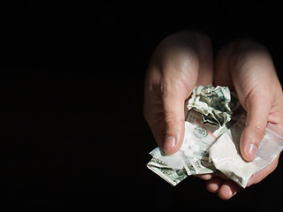 Image showing close up of addict hands with drugs and money