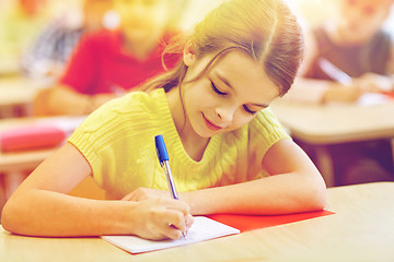 Image showing group of school kids writing test in classroom