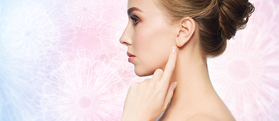 Image showing beautiful woman pointing finger to her ear