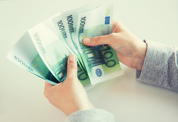 Image showing close up of woman hands counting euro money