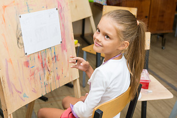 Image showing Girl happily looks at the teacher at a drawing lesson