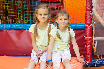 Image showing Two girls sit on a soft exit from the game room