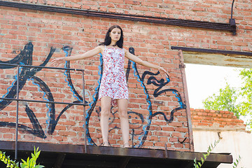 Image showing She wants to suicide jump off the balcony of a ruined building