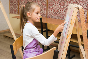 Image showing Girl artist with a smile look in the picture on the drawing lesson