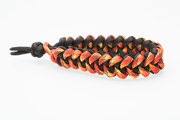 Image showing black and orange braided bracelet on white background