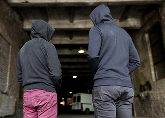 Image showing addict men or criminals in hoodies on street