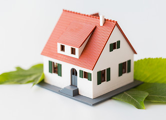 Image showing close up of house model and green leaves