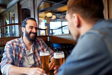 Image showing happy male friends drinking beer at bar or pub