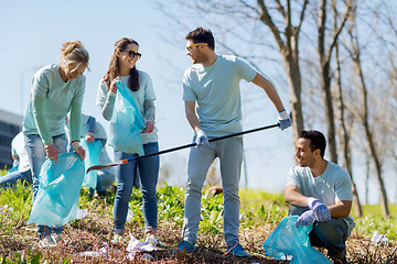 Image showing volunteers with garbage bags cleaning park area