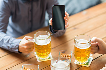 Image showing close up of friends with smartphone and beer