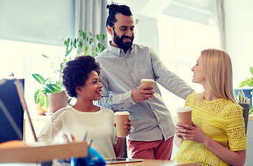 Image showing happy creative team drinking coffee in office