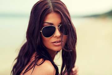 Image showing young woman with sunglasses on beach