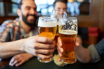 Image showing happy male friends drinking beer at bar or pub