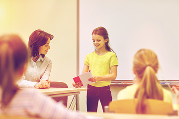 Image showing group of school kids with teacher in classroom