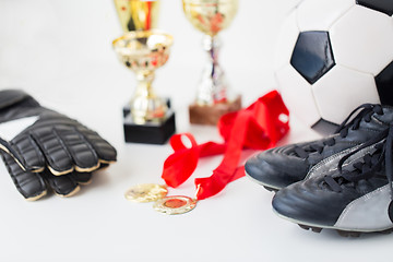 Image showing close up of football, boots, gloves, cup and medal
