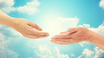 Image showing close up of senior and young woman hands