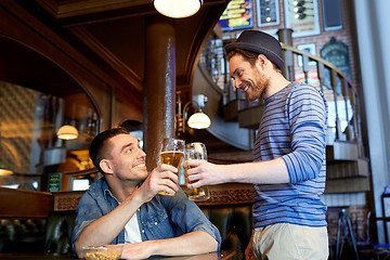 Image showing happy male friends drinking beer at bar or pub