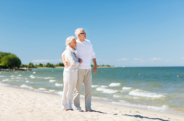 Image showing happy senior couple hugging on summer beach