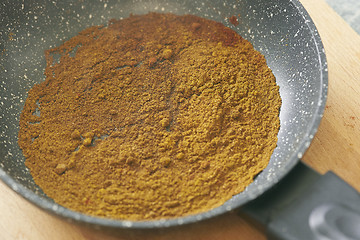 Image showing different spices paprika curry garam massala in pan