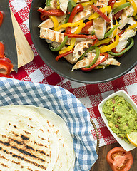 Image showing delicious wrap tortilla with spicy chicken vegetables guacamole