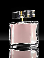 Image showing pink elegant perfume bottle in black background