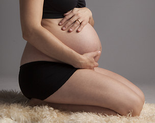 Image showing Pregnant Woman holding her hands on beautiful belly