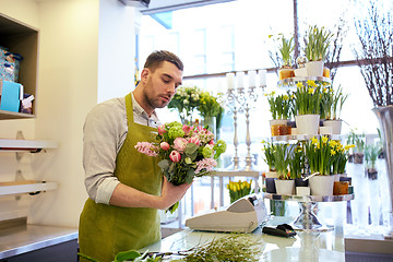 Image showing florist man making bunch at flower shop