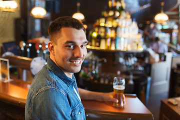 Image showing happy man drinking beer at bar or pub