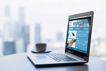 Image showing close up of laptop and coffee cup on office table